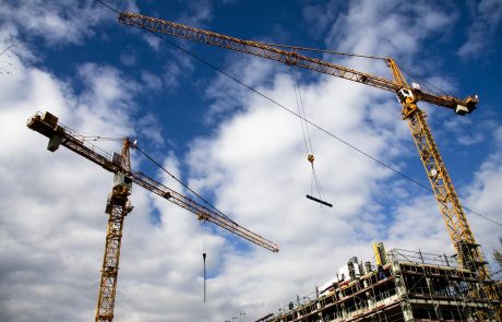 Construction, Manufacturing, Unions construction cranes with blue and white sky